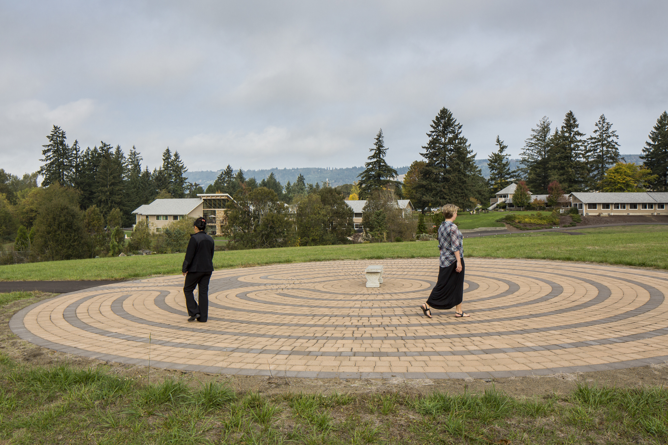 Two individuals walking the maze trail in Newberg