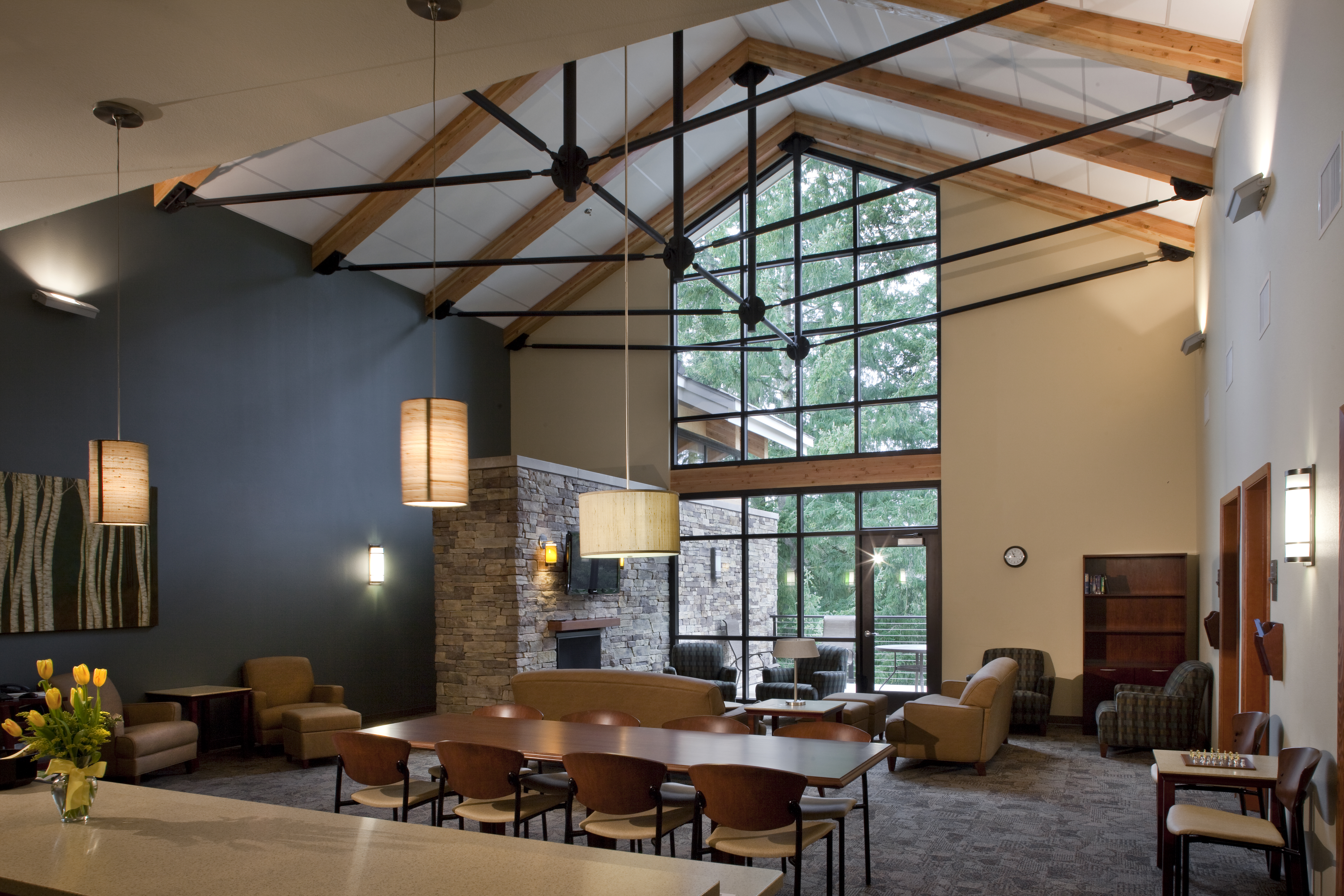 Inside the newberg lounge with tall ceilings and comfortable chairs and a community table
