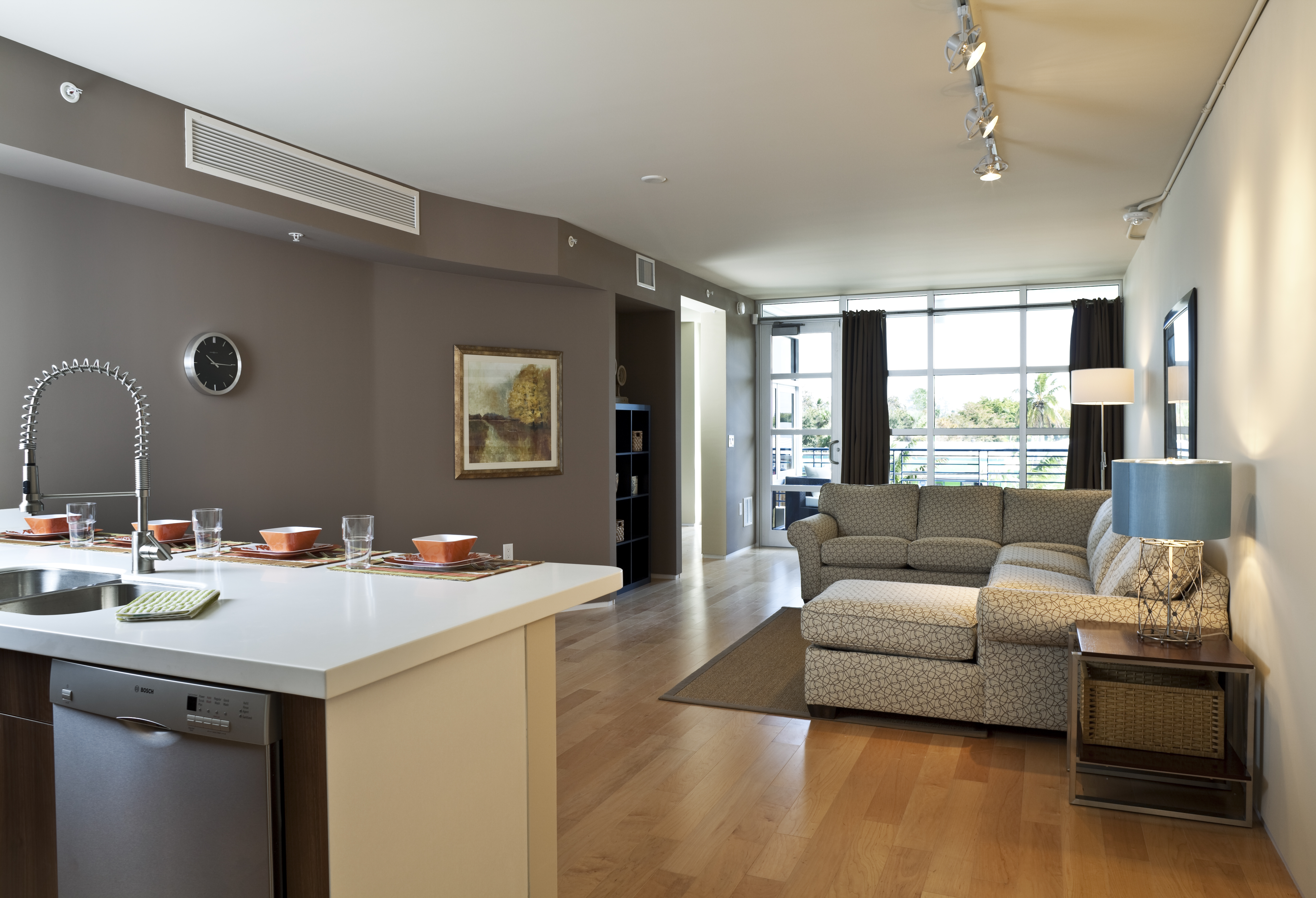 A modern kitchen and living room view from inside a Naples condominium