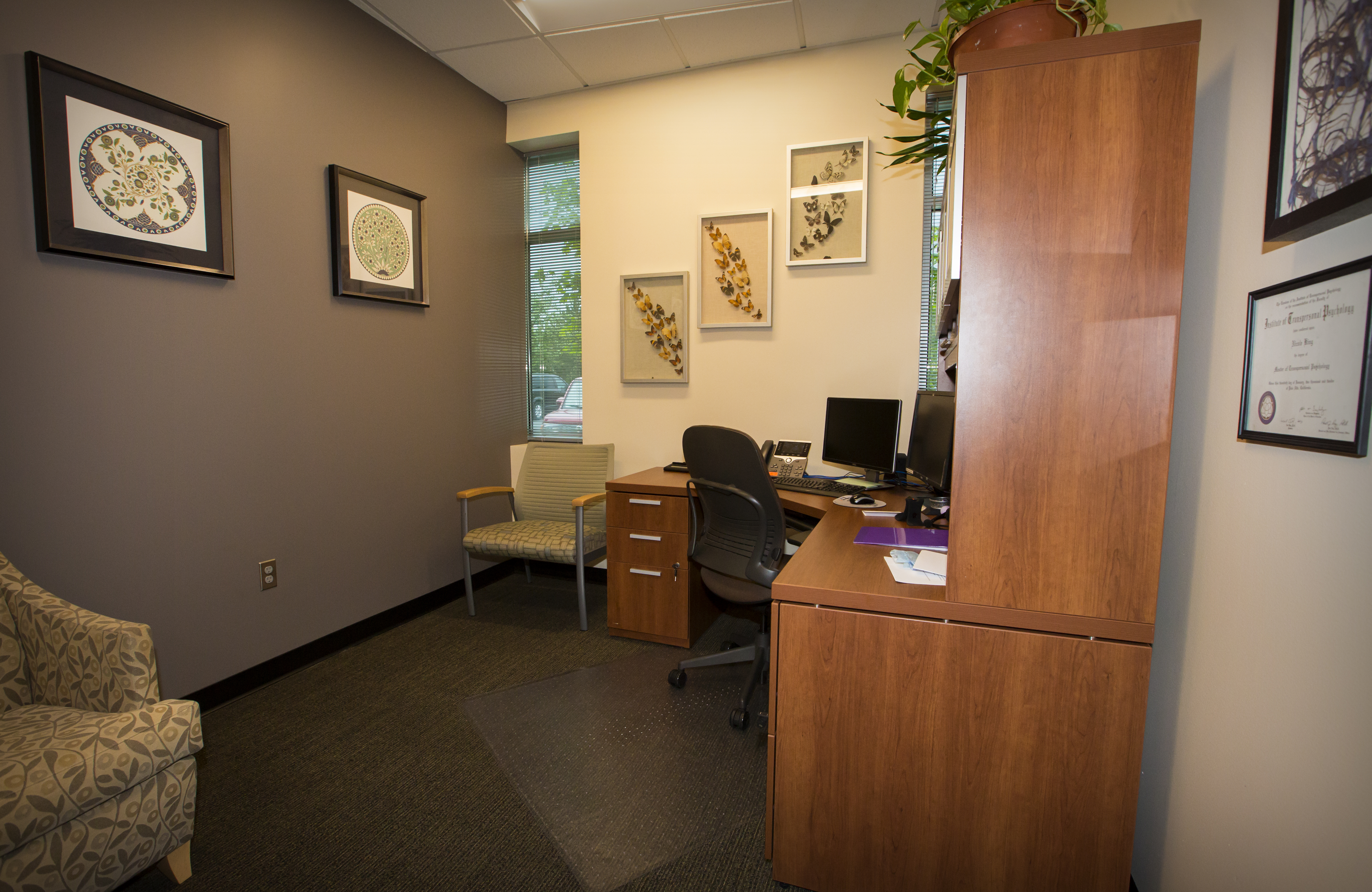 Inside one of the Beaverton offices furnished with a desk and comfortable chairs